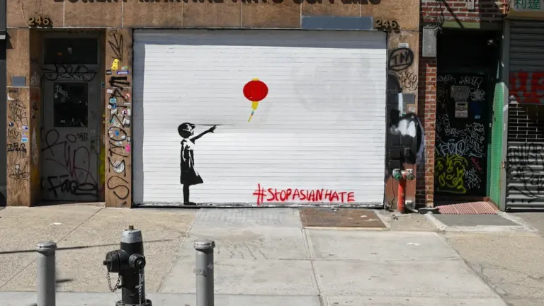 Ein Graffiti zeigt ein Kind, das eine rote chinesische Laterne loslässt, inklusive Hashtag StopAsianHate.